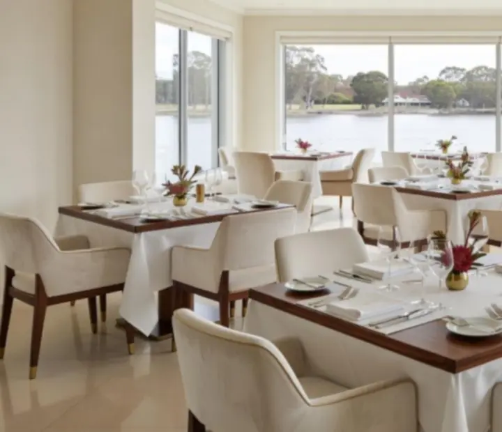 Softly lit dining room at Potand Platter with neatly set tables and warm natural tones.